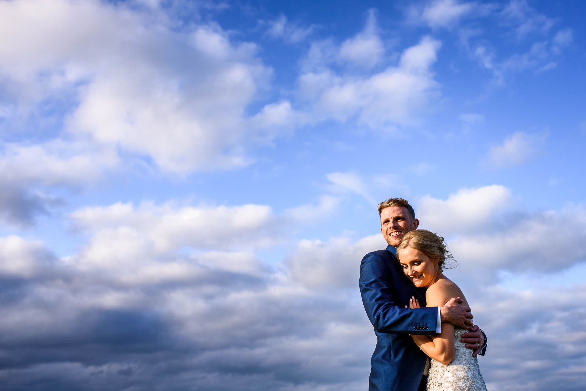 Bride and Groom pose with Stone skyline in the background