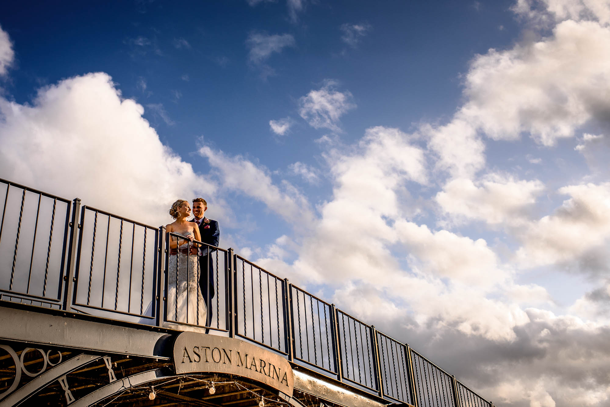 Natural candid relaxed portrait of Bride and Groom on bridge at Aston Marina.